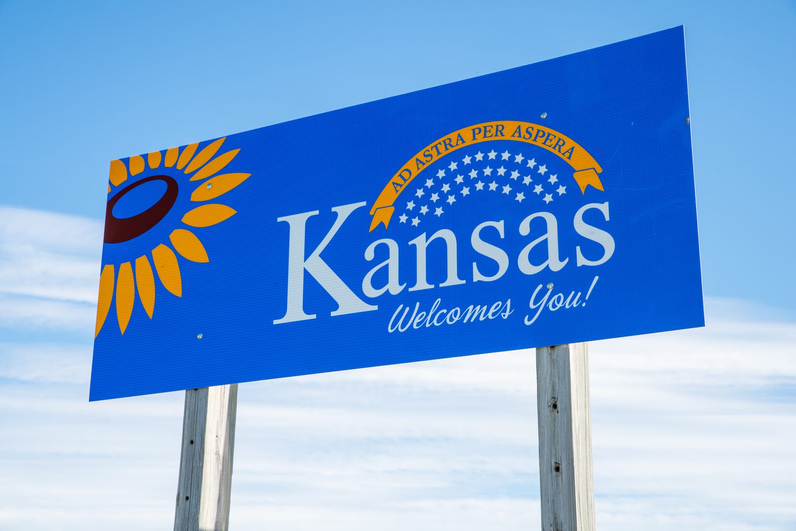 Kansas Welcomes You highway sign with sunflower — Kansas chiropractic CE requirements guide