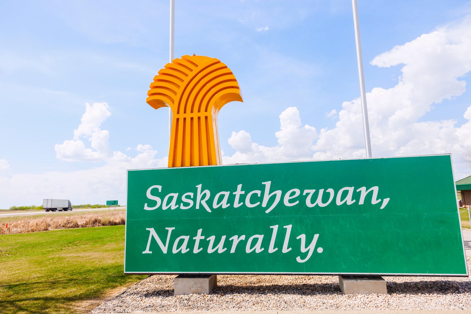“Saskatchewan, Naturally” highway welcome sign with the golden wheat sheaf under a prairie sky — Saskatchewan chiropractic continuing education requirements, CCEDseminars