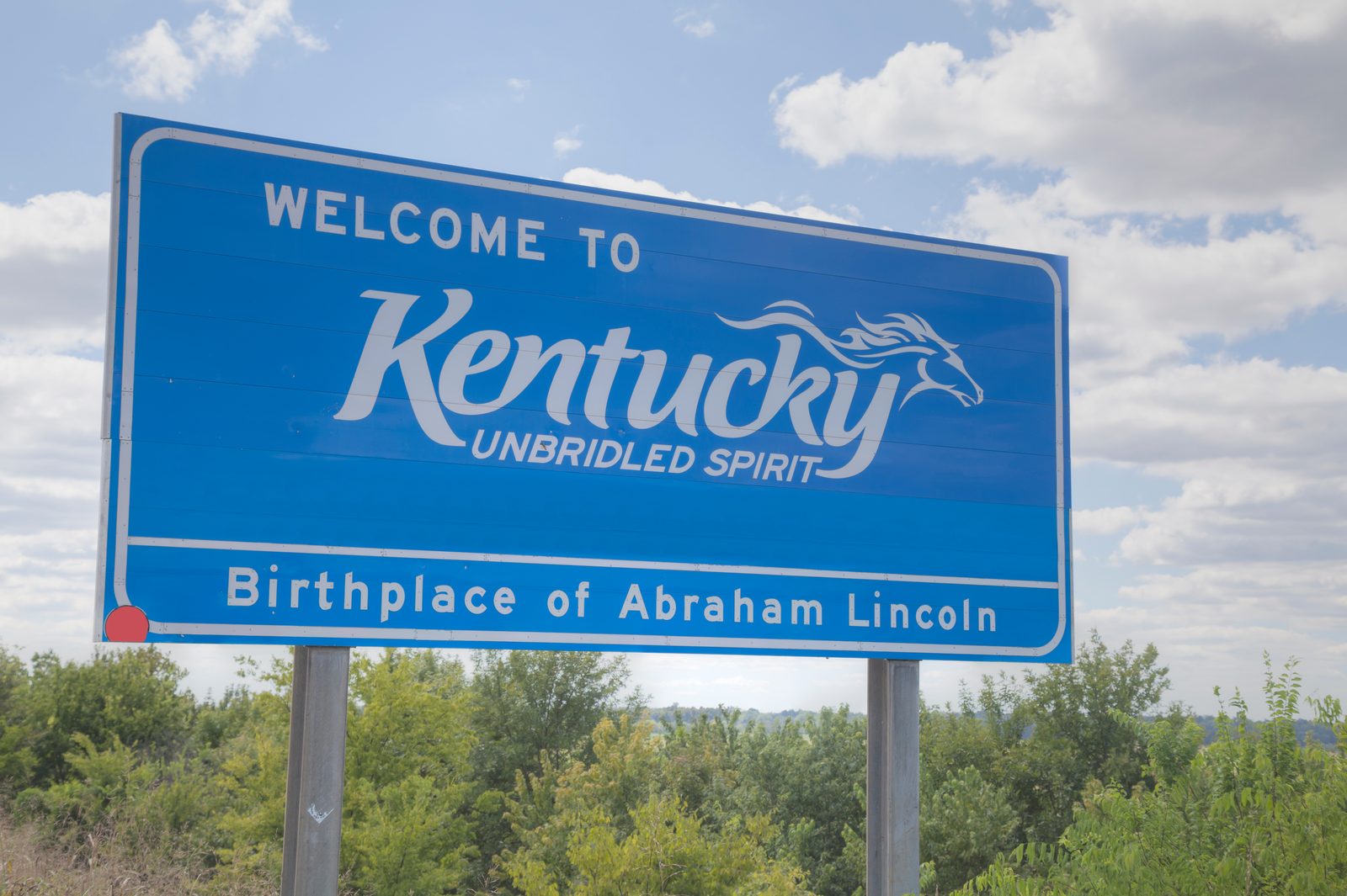 Welcome to Kentucky Unbridled Spirit highway sign — Kentucky chiropractic CE requirements guide