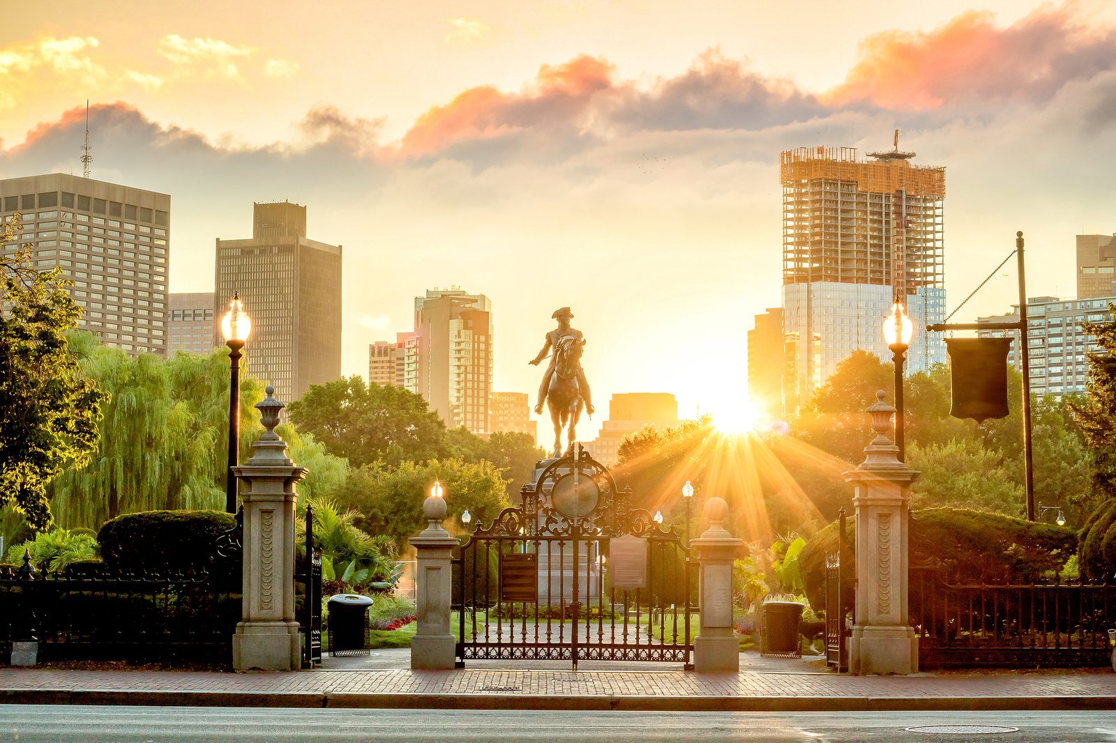 Boston Public Garden gate and skyline at sunrise — Massachusetts chiropractic CE guide, CCEDseminars