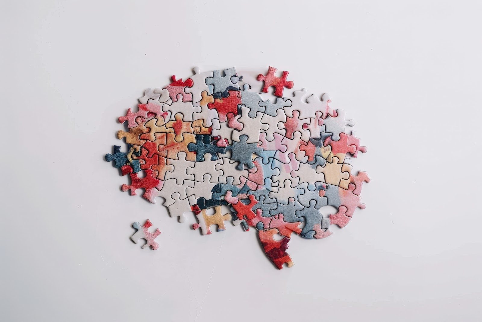 Human brain formed from interlocking jigsaw puzzle pieces on a white background