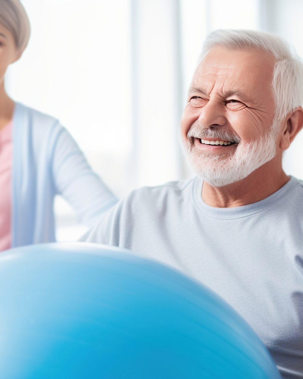 Senior patient exercising on a stability ball with clinician support — geriatrics CE courses for chiropractors; CCEDseminars category page