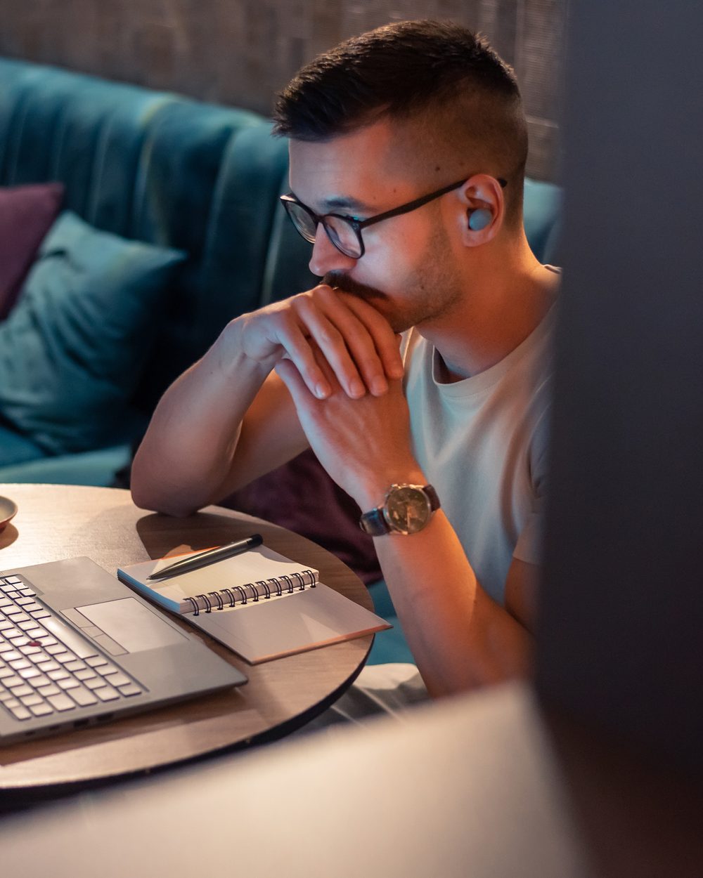 Doctor completing online continuing education on a laptop with notebook — state chiropractic CE course bundles; CCEDseminars category page