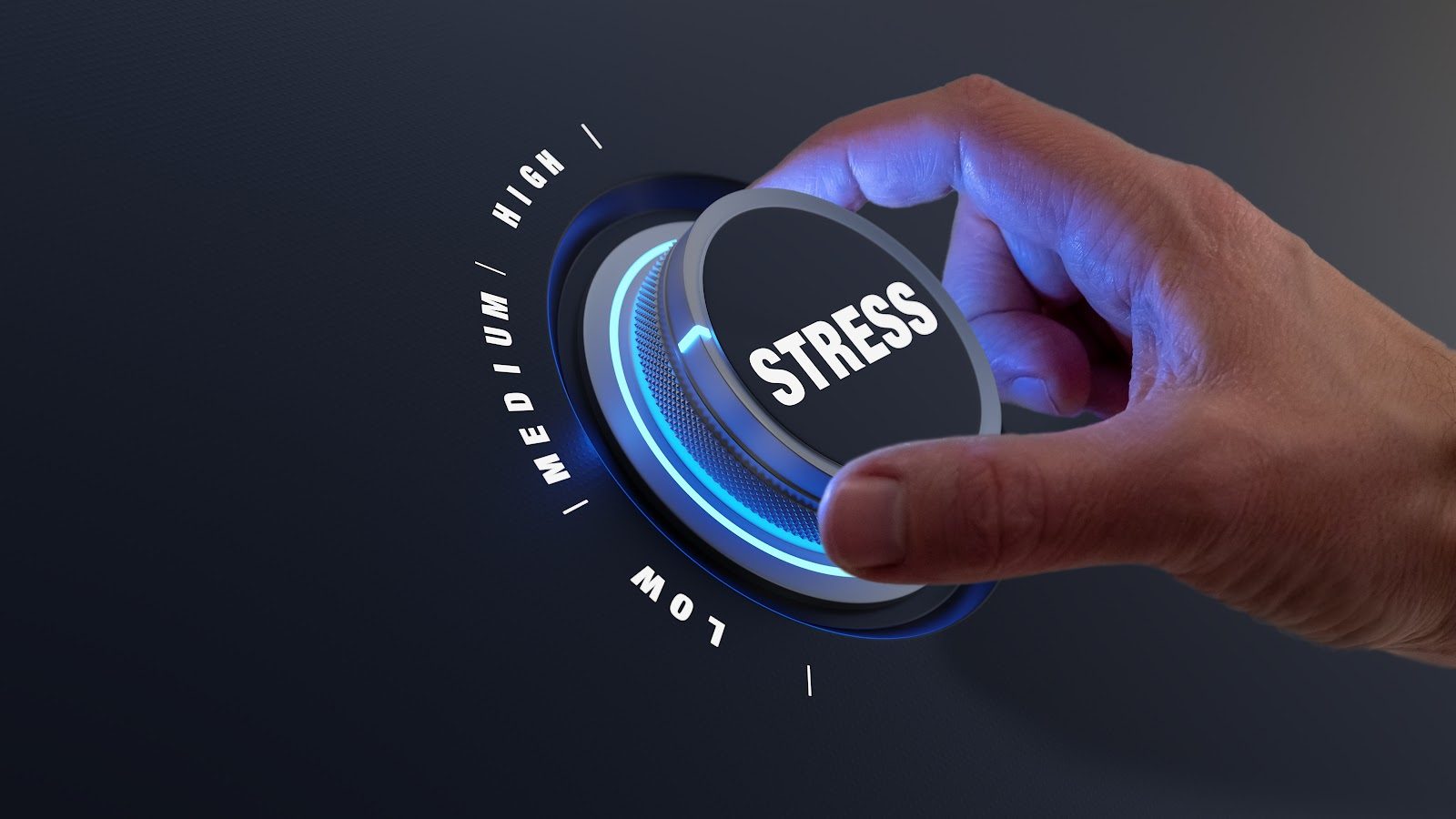 Hand turning a dial labeled Stress down from high toward low against a dark blue background