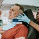 Paramedics fitting a cervical collar to an injured driver at a motor vehicle collision — CPIS whiplash and trauma imaging CE bundle for chiropractors, CCEDseminars